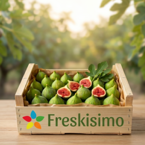 Wooden crate filled with fresh green figs, some halved to show pink flesh, on a wooden table.