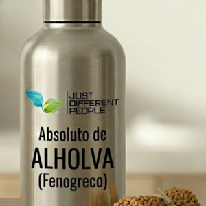 Stainless steel bottle labeled Absoluto de ALHOLVA (Fenogreco) with a bundle of fenugreek seeds beside it on a wooden surface.