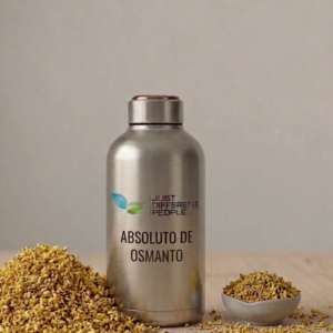 Shiny metal bottle with the text 'ABSOLUTO DE OSMANTO' and a green leaf logo, beside piles of granola on a wooden surface.