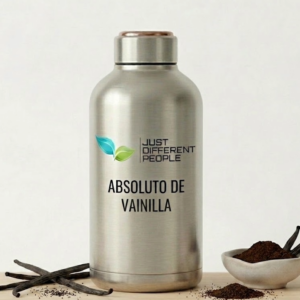 Silver stainless steel bottle labeled 'Absoluto de Vainilla' by Just Different People, with vanilla pods nearby.