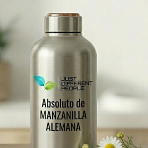 Stainless steel bottle with a logo and the words 'Just Different People' and 'Absoluto de Manzanilla Alemana', on a wooden surface with daisies nearby.