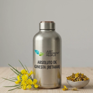 Stainless steel bottle with label 'ABSOLUTO DE GINESTA (RETAMA)' and a green leaf logo; yellow flowers and a bowl of seeds beside it on a wooden surface.