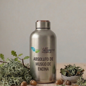 Stainless steel bottle with Just Different People logo, labeled Absoluto de Musgo de Encina, surrounded by moss and acorns on a wooden surface